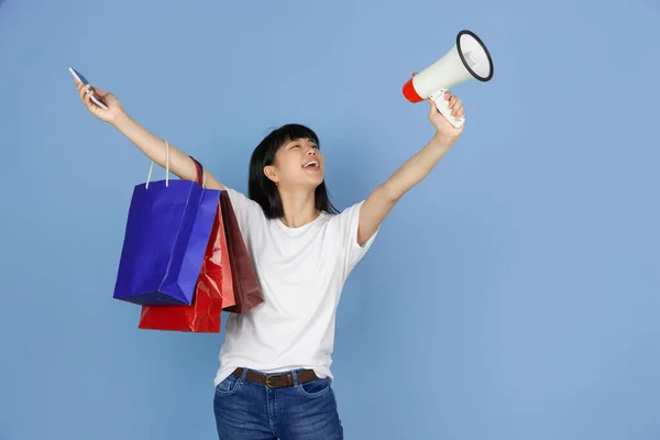 Portrait of young asian woman isolated on blue studio background — Stock Photo, Image