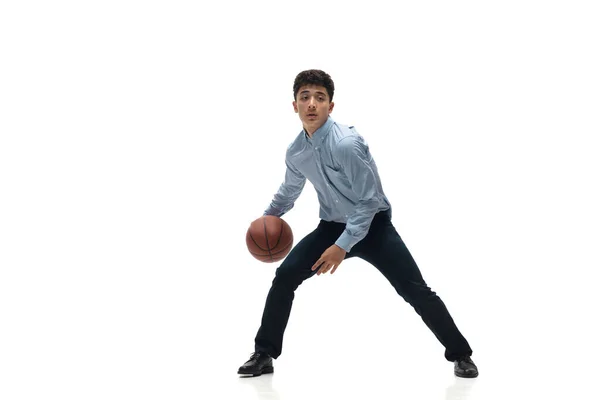 Man in office clothes playing basketball on white background. Unusual look for businessman in motion, action. Sport, healthy lifestyle. — Stock Photo, Image