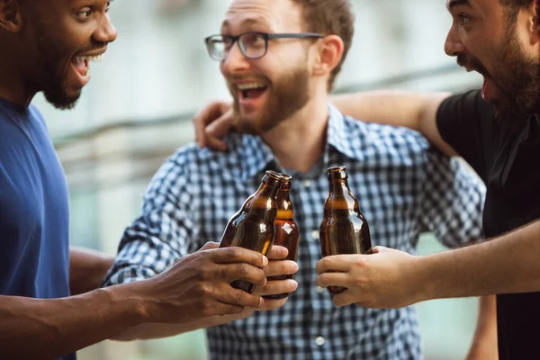 Μια ομάδα χαρούμενων φίλων κάνουν πάρτι μπύρας το καλοκαίρι. Ξεκουράζονται μαζί σε εξωτερικούς χώρους, γιορτάζοντας και χαλαρώνοντας, επαινώντας. Καλοκαιρινό τρόπο ζωής, φιλία. — Φωτογραφία Αρχείου