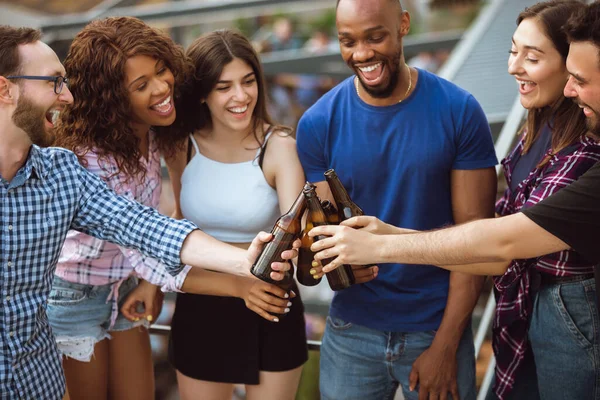 Grupo de amigos felices teniendo una fiesta de cerveza en el día de verano. Descansando juntos al aire libre, celebrando y relajando, riendo. Estilo de vida de verano, concepto de amistad . — Foto de Stock