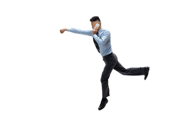 Man in office clothes practicing taekwondo on white background. Unusual look for businessman in motion, action. Sport, healthy lifestyle. — Stock Photo, Image