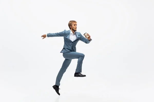 Man in office clothes running, jogging on white background. Unusual look for businessman in motion, action. Sport, healthy lifestyle. — Stock Photo, Image