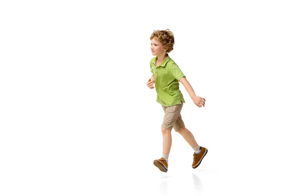 Happy little caucasian boy jumping and running isolated on white background — Stock Photo, Image