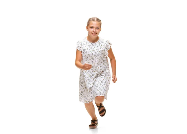 Happy little caucasian girl jumping and running isolated on white background — Stock Photo, Image