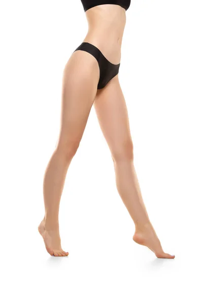 Pernas femininas bonitas, buttlocks e barriga isolada no fundo branco. Corpo esportivo e sensual com pele bem cuidada em roupa interior . — Fotografia de Stock