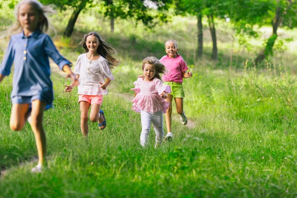 Kinder, Kinder, die im Sommer auf der Wiese laufen — Stockfoto