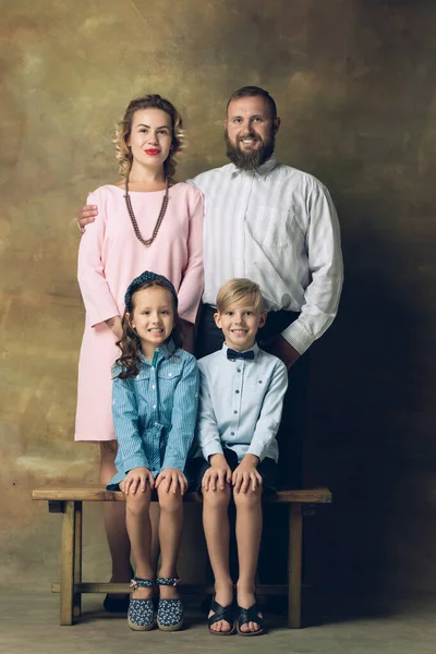Happy family traditional portrait, old-fashioned. Cheerful parents and kids