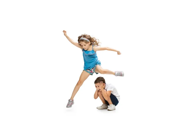 Happy little caucasian girl and boy jumping and running isolated on white background — Stock Photo, Image