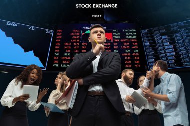 Nervous tensioned investors analyzing crisis stock market with charts on screen on background, falling stock exchange clipart