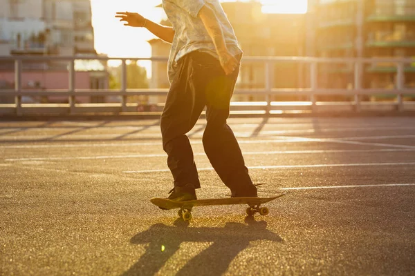 Skateboarder doing a trick at the citys street in summers sunshine