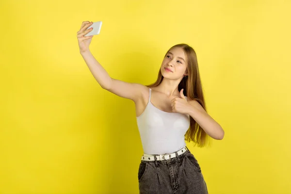 Portrait de jeunes filles caucasiennes isolées sur fond jaune studio. Belle mannequin féminine. Concept d'émotions humaines, expression faciale, ventes, publicité, culture de la jeunesse. — Photo