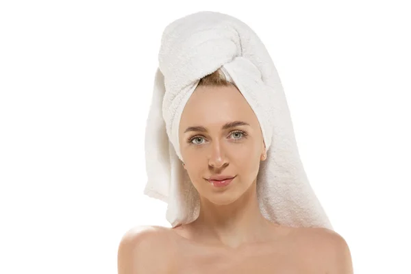 La journée beauté. Femme portant une serviette faisant sa routine quotidienne de soins de la peau. Portrait isolé sur fond de studio blanc — Photo