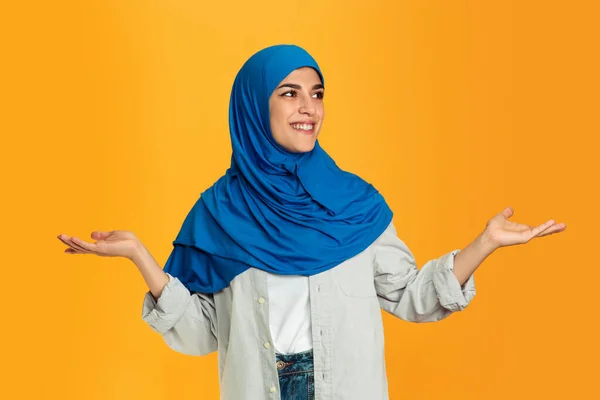 Retrato de jovem muçulmano mulher isolada no fundo do estúdio amarelo — Fotografia de Stock
