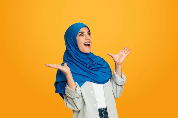 Portrait of young muslim woman isolated on yellow studio background — Stock Photo, Image