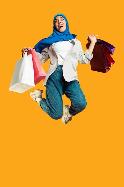 Portrait of young muslim woman isolated on yellow studio background — Stock Photo, Image