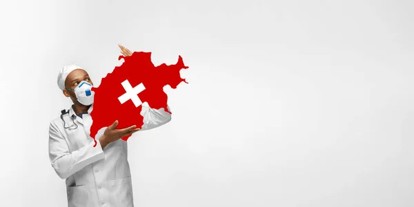 Beautiful african-american doctor cares about Switzerland isolated over white studio background