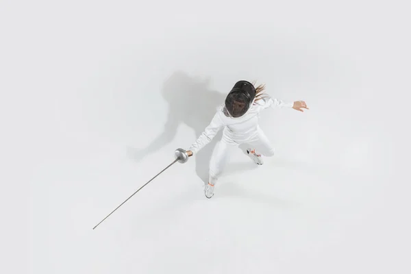 Дівчина-підліток в костюмі фехтування з мечем в руці ізольована на білому тлі, вид зверху — стокове фото
