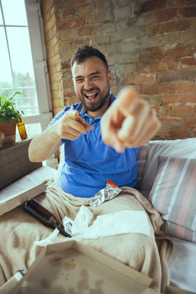 Lazy man living the whole life in his bed surrounded with messy