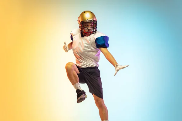American football player isolated on gradient studio background in neon light — Stock Photo, Image