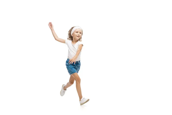 Happy little caucasian girl jumping and running isolated on white background — Stock Photo, Image