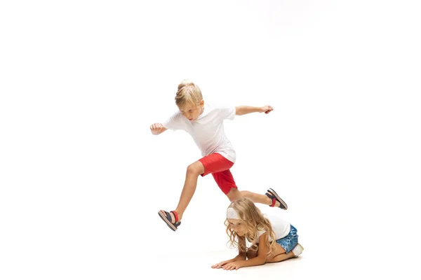 Feliz niña caucásica y chico saltando y corriendo aislado sobre fondo blanco — Foto de Stock