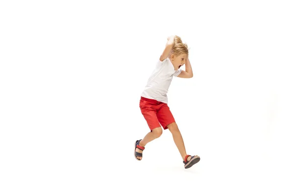 Щасливий маленький білий хлопчик стрибає і біжить ізольовано на білому тлі — стокове фото
