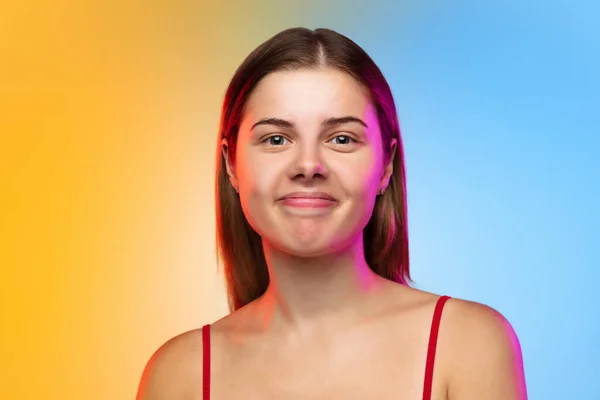 Caucasian young womans portrait on gradient studio background in neon — Stock Photo, Image