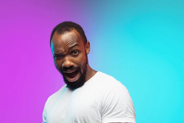 African-american young mans portrait on gradient studio background in neon, close up — Stock Photo, Image