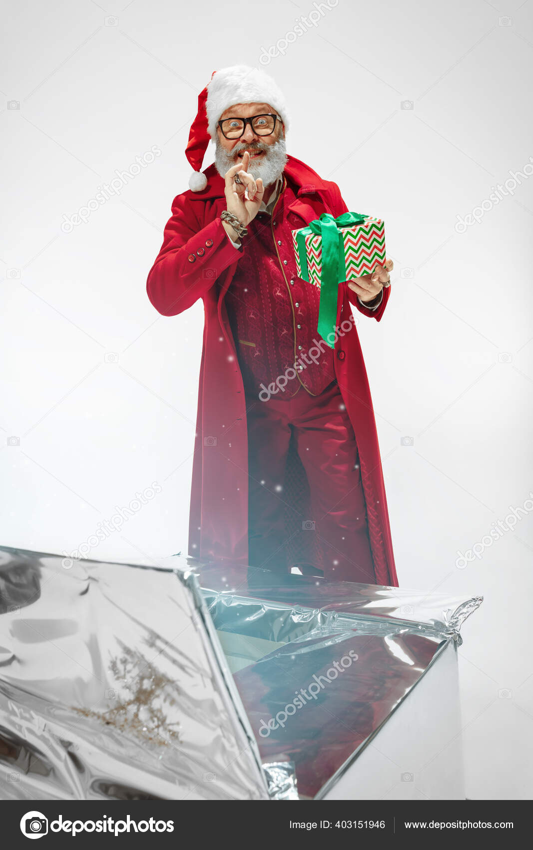 Modern stylish Santa Claus in red fashionable suit isolated on