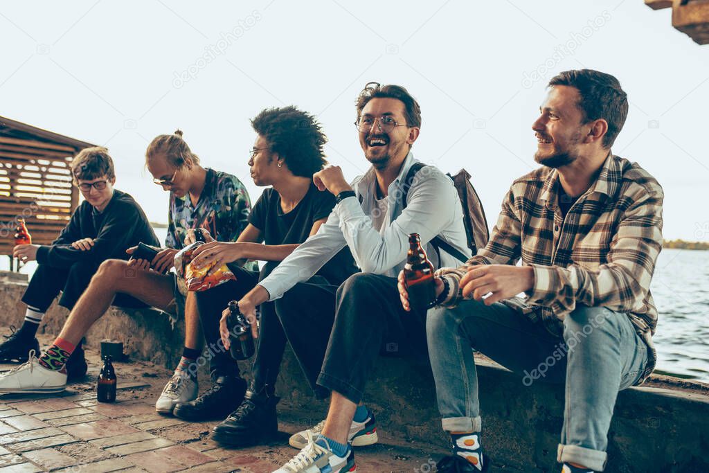 Group of friends celebrating, resting, having fun and party in summer day