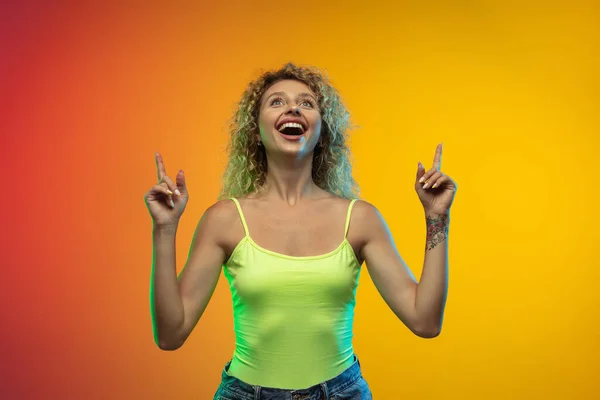 Caucásico joven mujer retrato en gradiente estudio fondo en neón —  Fotos de Stock