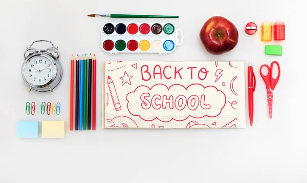 Colorful school supplies corner border over a white background with words Back to school — Stock Photo, Image