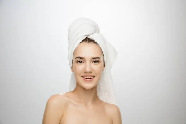 Schönheitstag. Frau trägt Handtuch isoliert auf weißem Studiohintergrund — Stockfoto