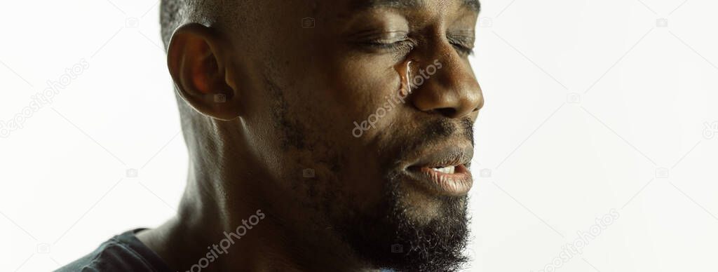 African-american young mans close up shot on studio background, flyer