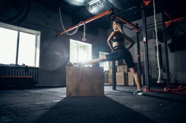 Spor salonunda sıkı çalışan bayan sporcu. Fitness ve sağlıklı yaşam konsepti.