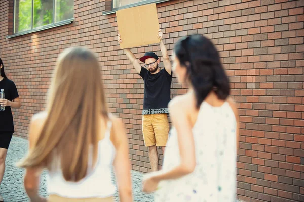 Dude with sign - man stands protesting things that annoy him