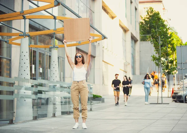 Dude with sign - woman stands protesting things that annoy her