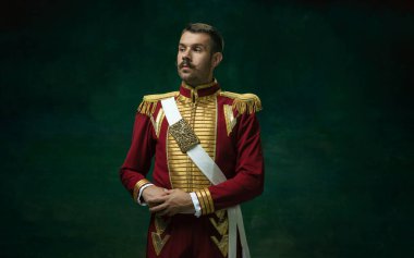 Nicholas II gibi koyu yeşil arka planda genç bir adam. Retro biçimi, dönemin karşılaştırması.