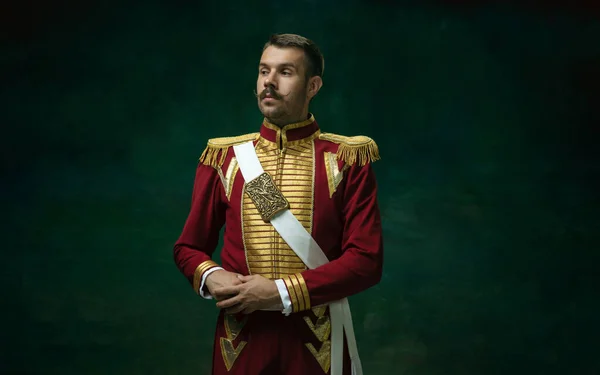 Young man as Nicholas II on dark green background. Retro style, comparison of eras concept. — Stock Photo, Image