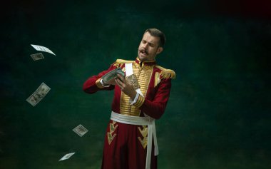 Young man as Nicholas II on dark green background. Retro style, comparison of eras concept. clipart