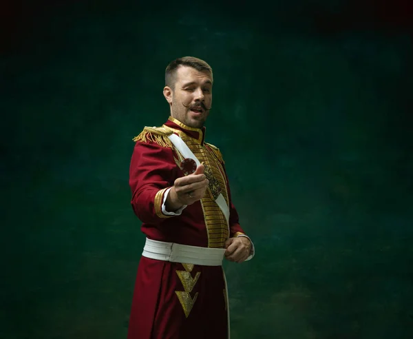 Young man as Nicholas II on dark green background. Retro style, comparison of eras concept. — Stock Photo, Image