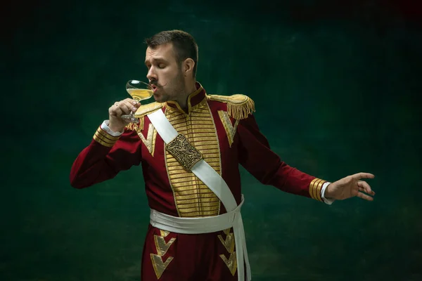 Young man as Nicholas II on dark green background. Retro style, comparison of eras concept. — Stock Photo, Image