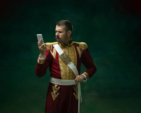 Young man as Nicholas II on dark green background. Retro style, comparison of eras concept. — Stock Photo, Image