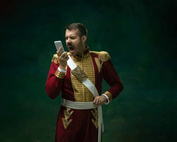 Young man as Nicholas II on dark green background. Retro style, comparison of eras concept. — Stock Photo, Image