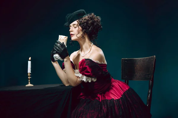 Young woman as Anna Karenina on dark blue background. Retro style, comparison of eras concept. — Stock Photo, Image