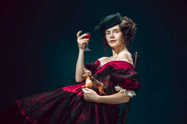 Young woman as Anna Karenina on dark blue background. Retro style, comparison of eras concept. — Stock Photo, Image