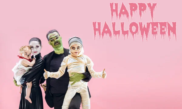 Young family as zombies on pink background, halloween time, flyer with copyspace — Stock Photo, Image