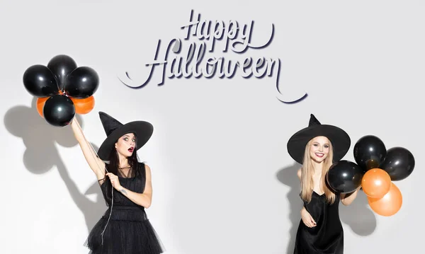 Young attrective women in hat as a witch on scary background — Stock Photo, Image