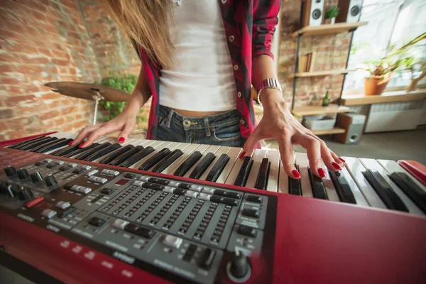 Mujer grabando música, cantando y tocando el piano mientras está de pie en el lugar de trabajo o en casa —  Fotos de Stock