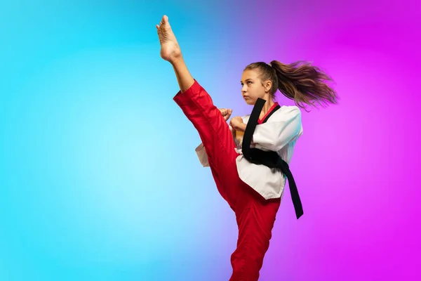 Karate, taekwondo dziewczyna z czarnym pasem izolowane na gradientowym tle w świetle neonu — Zdjęcie stockowe